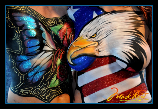 chest of one woman with an elaborate butterfly design and chest of another woman with an elaborate bald eagle head over an american flag